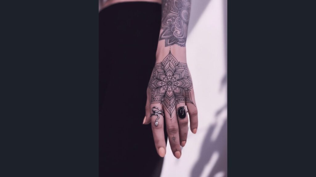 A woman’s hand with a floral cover-up tattoo hiding an old design, featuring detailed petals and decorative patterns.