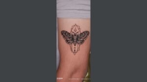 Minimalist small hand tattoo on a man’s finger, featuring a tiny geometric symbol with subtle and masculine style.