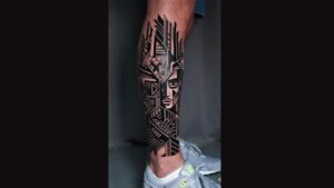 Half leg sleeve tattoo featuring tribal and geometric patterns with animal elements, creating a bold and masculine leg design.